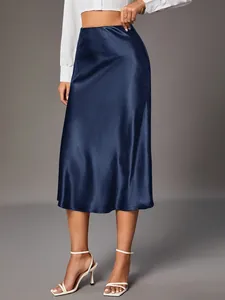 Close-up of navy blue satin midi skirt showing elegant silk-like fabric sheen and fit.