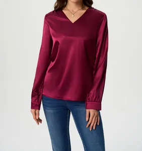 Close-up detail of an elegant wine red long sleeve satin blouse featuring a V-neckline