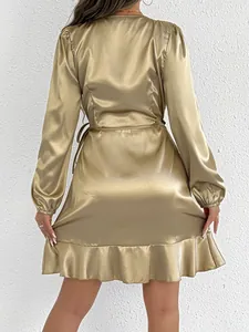 Back view of a gold satin long-sleeved dress featuring a ruffle hem and waist tie