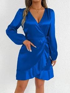 Elegant royal blue satin long-sleeve wrap dress featuring chic ruffle hem details