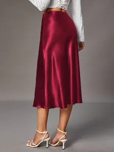 Elegant wine red satin midi skirt with silky glossy finish shown from rear view