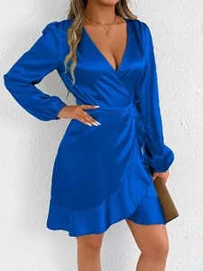Detailed shot of an elegant royal blue satin long-sleeved wrap dress featuring a V-neck line