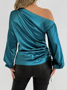 Back view of a teal satin one-shoulder long sleeve blouse with elegant silk sheen texture.