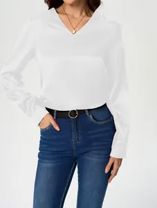 Macro view of elegant white long-sleeved satin blouse for women with V-neckline.
