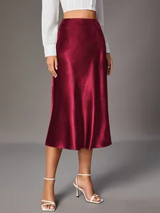 Elegant burgundy satin midi skirt showing high-waisted fit and silky fabric texture.