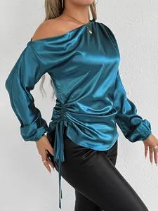 Close-up detail of elegant teal blue satin off-shoulder blouse with side drawstring feature