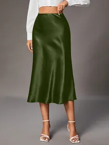 Close-up of a luxurious dark green satin midi skirt featuring an elegant glossy finish.
