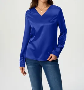Elegant royal blue long-sleeve satin blouse with a sleek V-neck design worn by a model.