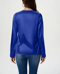 Back view detail of a long-sleeved deep blue satin blouse with silk-like texture