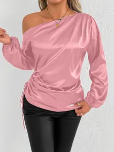 Detail view of pink satin one-shoulder blouse with long lantern sleeves for women