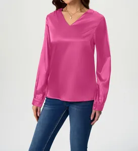 Detail shot of a vibrant magenta long sleeve satin blouse featuring a V-neckline
