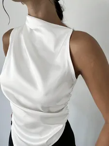 Close-up of elegant white satin sleeveless blouse with draped neck and side ruching