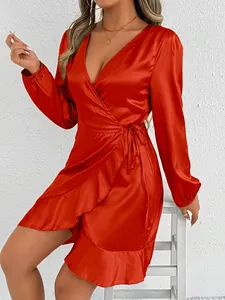 Elegant red satin long sleeve wrap dress featuring a stylish ruffle hem detail shown on model.