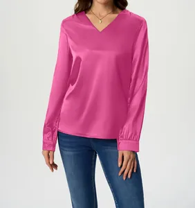 Close-up detail of a vibrant fuchsia pink satin V-neck long sleeve shirt for women