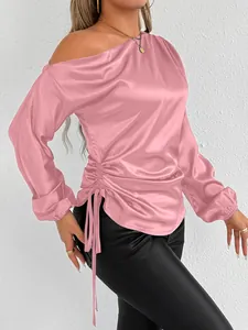 Close-up of pink satin off-shoulder long sleeve blouse with side drawstring detail