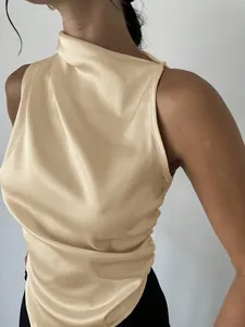 Close-up view of an elegant champagne satin sleeveless blouse featuring a draped neckline detail