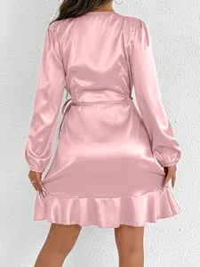 Detailed back view of a pink satin long-sleeved dress with elegant ruffle hem