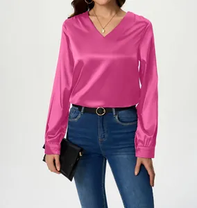 Detail view of elegant hot pink long-sleeved satin blouse with a stylish V-neck design.
