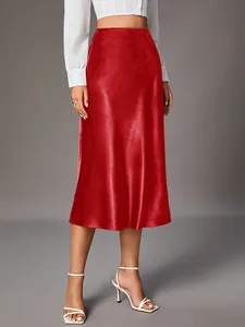 Elegant high-waisted red satin midi skirt featuring a smooth glossy finish on a model