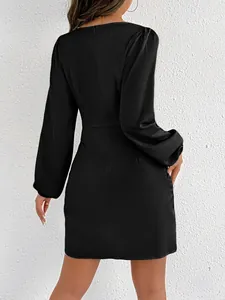 Back view detail showing the sleek fit of a black satin long-sleeve bodycon mini dress