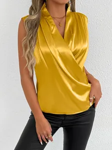 Close-up detail of an elegant mustard yellow satin sleeveless blouse with a wrap V-neck