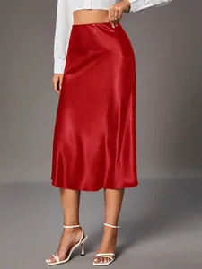 Close-up of elegant red satin midi skirt with glossy finish and smooth A-line drape