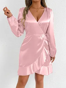 Elegant pink satin long-sleeved wrap dress with a stylish ruffle hem and deep V-neckline.