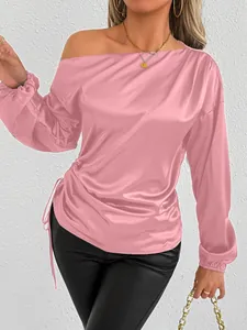 Detailed view of an elegant pink satin long sleeve shirt with asymmetric neckline