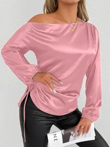 Close-up of elegant pink satin off-shoulder long sleeve top with side drawstring detail