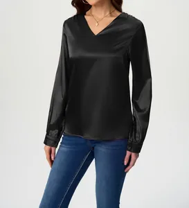 Detailed view of women's black satin blouse with elegant V-neck and silky texture.