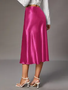 Back view of an elegant magenta satin midi skirt featuring a luxurious glossy finish texture