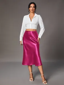 Elegant magenta satin midi skirt featuring high gloss finish and fluid silk-like drape