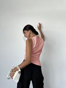 Elegant pink satin sleeveless blouse with smooth silk-like texture shown from behind