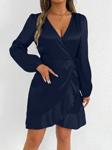Elegant navy blue satin long-sleeved wrap dress featuring a chic ruffle hem detail