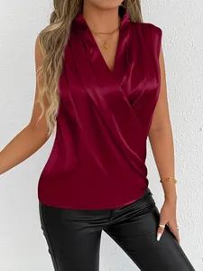 Detail of wine red sleeveless satin blouse with elegant draped V-neck design.
