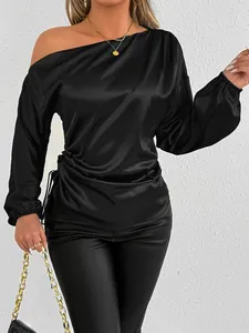 Elegant black satin off-shoulder long-sleeve blouse detail showing smooth texture and cuff