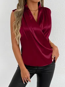 Close-up detail of a wine red satin sleeveless blouse with a draped wrap V-neck.