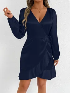 Detailed view of elegant navy blue satin long-sleeved wrap dress with ruffle hemline