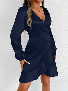 Elegant navy blue satin long sleeve wrap dress featuring delicate ruffle hem and V-neckline