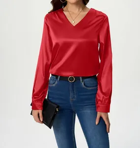 Detail view of women's red V-neck satin blouse featuring long sleeves and silky texture