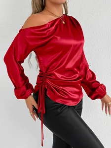 Detail view of a red satin off-shoulder long-sleeve blouse with side drawstring