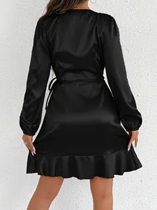 Back view of elegant black satin long-sleeved dress with ruffled hem and waist tie