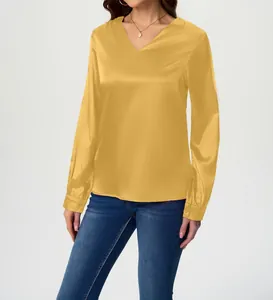 Close-up detail of an elegant yellow satin V-neck long-sleeved blouse for women in studio