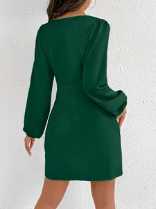 Rear view of elegant dark green satin long-sleeved mini dress with a bodycon fit