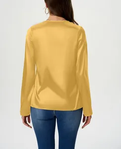 Detailed back view of a vibrant yellow long-sleeve satin blouse with silky texture
