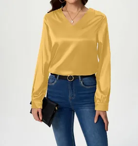 Close-up view of an elegant yellow V-neck long sleeve satin blouse with a silky finish.