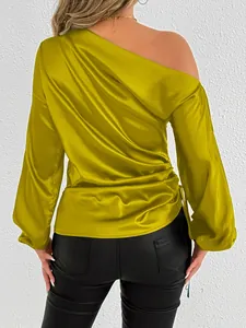 Detailed back view of lime yellow satin off-shoulder blouse showing elegant drape