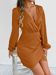 Detail view of elegant orange satin wrap dress featuring long elasticated sleeves