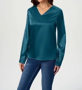 Close-up of teal satin long sleeve blouse showing smooth silk-like texture and V-neck