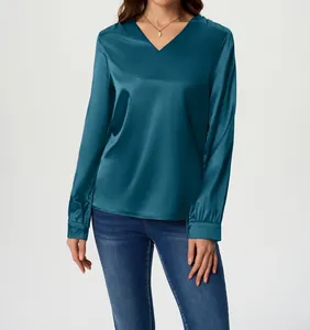 Close-up of elegant teal satin long-sleeved shirt with a stylish V-neck design
